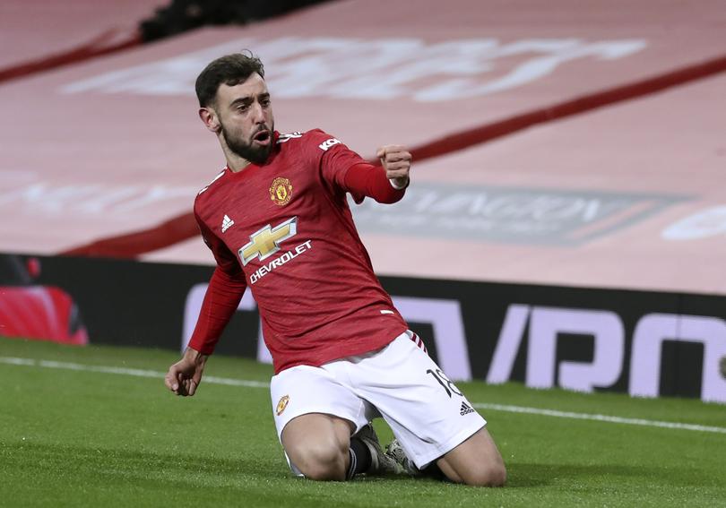 Manchester United's Bruno Fernandes celebrates after scoring his side's third goal during the English FA Cup 4th round soccer match between Manchester United and Liverpool at Old Trafford in Manchester, England, Sunday, Jan. 24, 2021. (Martin Rickett/Pool via AP)