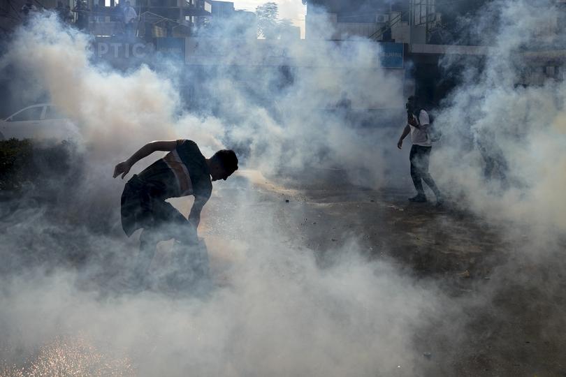 Riot police use tear gas against protesters during a demonstration, in solidarity with the Palestinian people, in Lebanon.