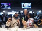 President Joe Biden takes photos with patrons during a campaign stop Thursday, Feb. 1, 2024.