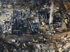 A car lies near burnt out houses and other debris after forest fires reached Vina del Mar, Chile.