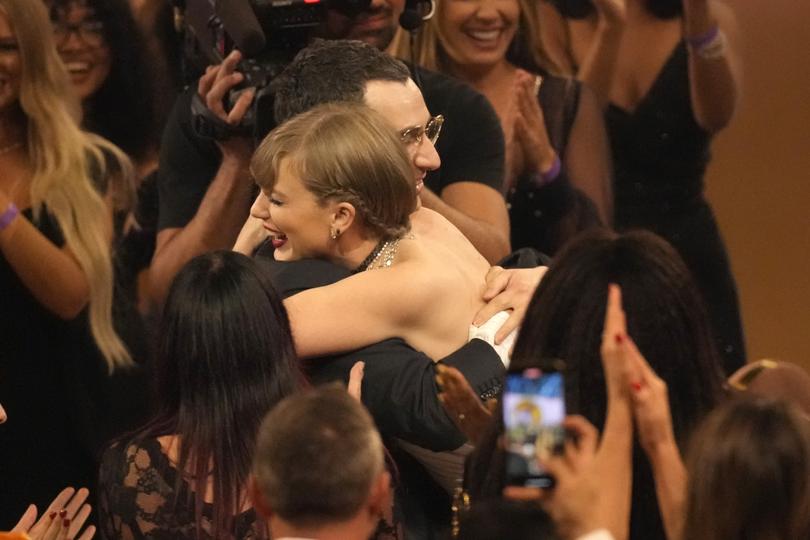 Jack Antonoff, left, and Taylor Swift embrace after winning album of the year for "Midnights" during the 66th annual Grammy Awards on Sunday, Feb. 4, 2024, in Los Angeles. (AP Photo/Chris Pizzello)