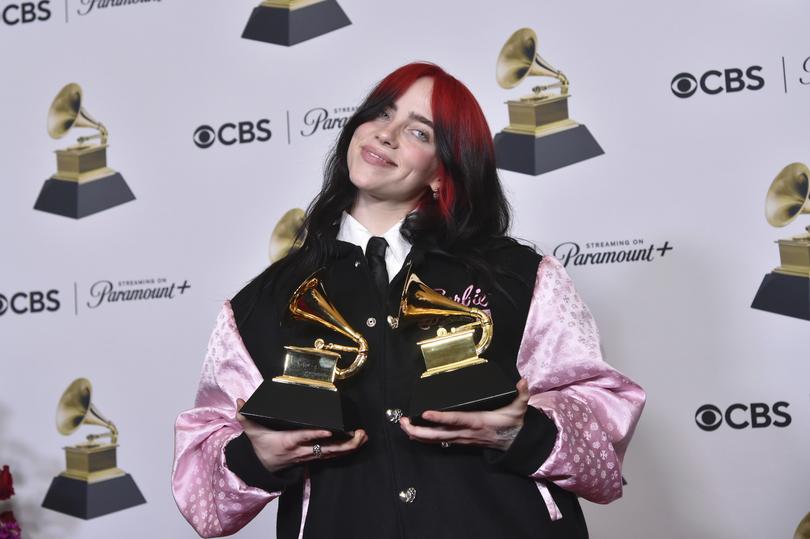 Billie Eilish poses in the press room with the awards for best song written for visual media and song of the year for "What Was I Made For?" from "Barbie the Album" during the 66th annual Grammy Awards on Sunday, Feb. 4, 2024, in Los Angeles. (Photo by Richard Shotwell/Invision/AP)