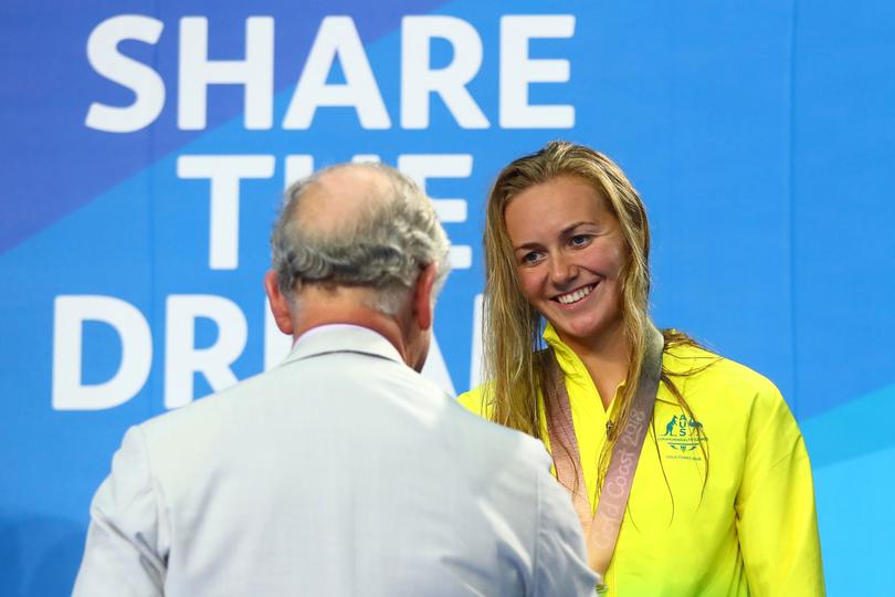 GOLD COAST, AUSTRALIA - APRIL 05: Prince Charles, Prince of Wales presents the silver medal to Ariarne Titmus of Australia during the medal ceremony for the Women's 200m Freestyle Final on day one of the Gold Coast 2018 Commonwealth Games at Optus Aquatic Centre on April 5, 2018 on the Gold Coast, Australia. (Photo by Clive Rose/Getty Images)