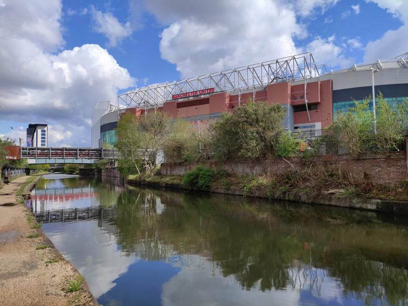 Pedalling by the Bridgewater Canal outside Old Trafford football stadium.