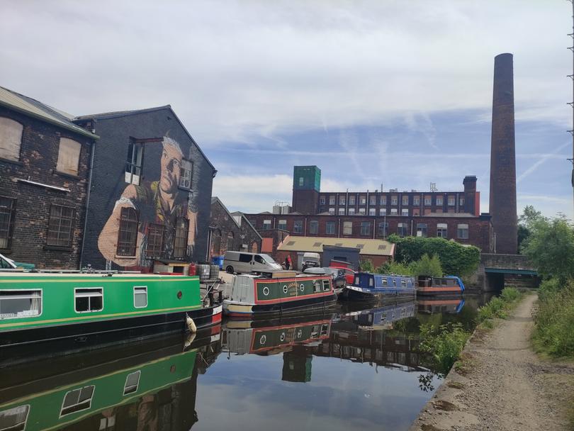 Cycling past Stalybridge along the Huddersfield Narrow Canal.