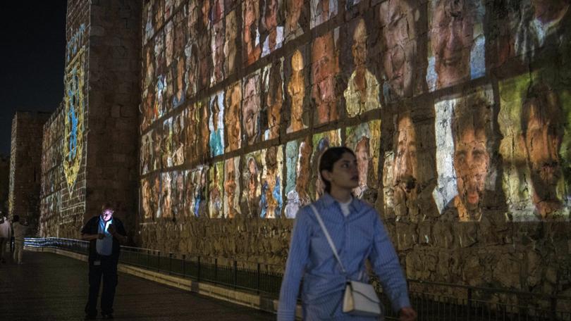 Images of those taken hostage by Hamas militants are projected on the outer wall of the Old City of Jerusalem.