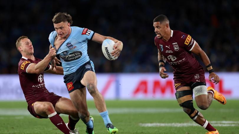 SYDNEY, AUSTRALIA - JUNE 08: Jack Wighton of the Blues is tackled by Daly Cherry-Evans of the Maroons during game one of the 2022 State of Origin series between the New South Wales Blues and the Queensland Maroons at Accor Stadium on June 08, 2022 in Sydney, Australia. (Photo by Cameron Spencer/Getty Images)