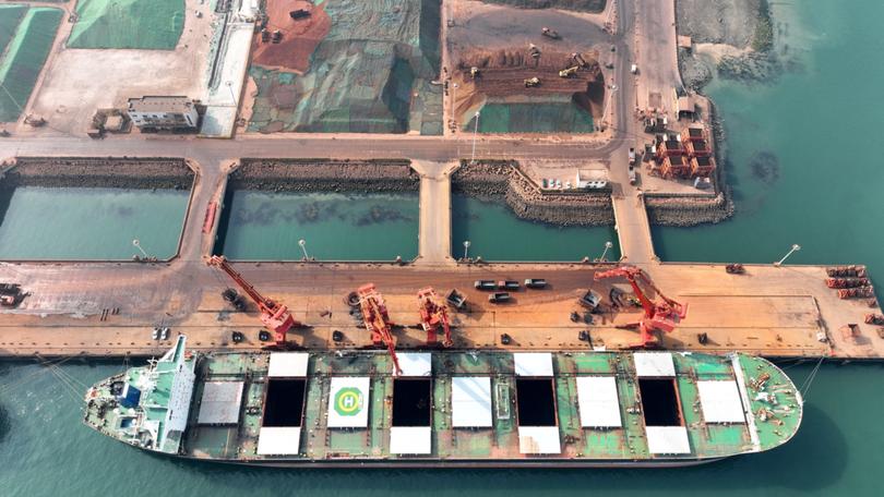 Imported iron ore being unloaded in China.