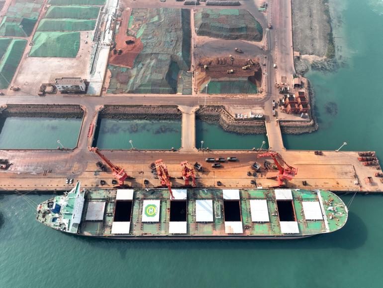 Imported iron ore being unloaded in China.