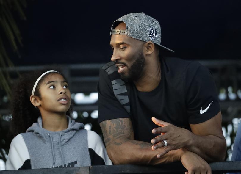 FILE - In this July 26, 2018, photo, former Los Angeles Laker Kobe Bryant and his daughter Gianna watch the U.S. national championships swimming meet in Irvine, Calif. A federal jury has found that Los Angeles County must pay Bryant's widow $16 million over photos of the NBA star's body at the site of the 2020 helicopter crash that killed him. The jurors who returned the verdict Wednesday, Aug. 24, 2022, agreed with Vanessa Bryant and her attorneys that her privacy was invaded when deputies and firefighters took and shared photos of the remains of Kobe Bryant and their 13-year-old daughter Gianna. (AP Photo/Chris Carlson, File)