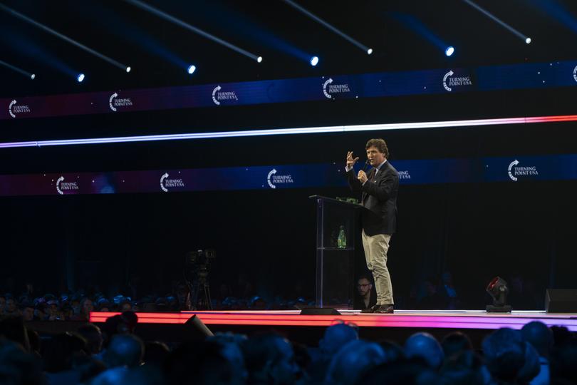 Tucker Carlson delivers remarks during Turning Point USA's AmericaFest at the Phoenix Convention Center in Phoenix in 2023.