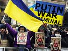 Pro-Ukraine demonstrators carry signs and Ukraine flags near Russia's UN Mission in 2022.