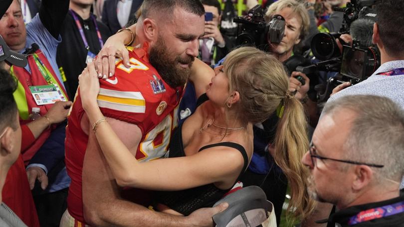 Kansas City Chiefs tight end Travis Kelce (87) embraces Taylor Swift after the NFL Super Bowl 58 football game.