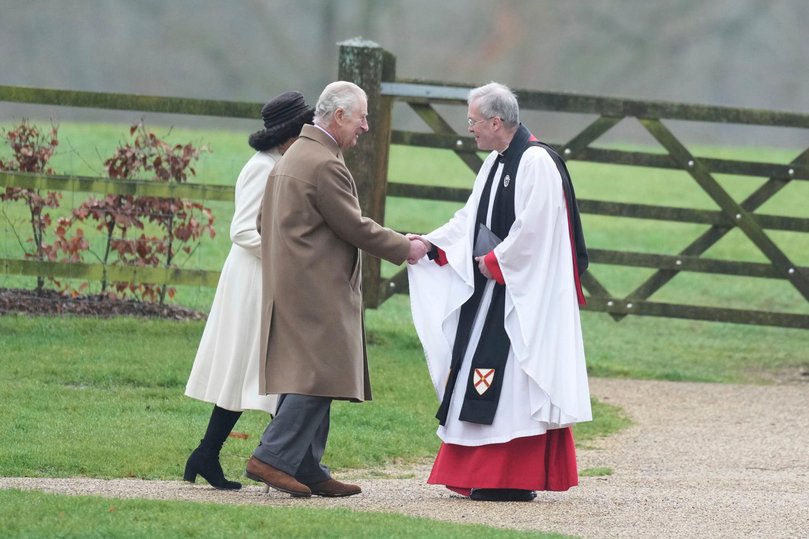 Britain's King Charles III and Queen Camilla are greeted by Canon Paul Williams as they arrive to attend a Sunday church service.