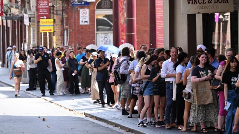 People line up to purchase Taylor Swift The Eras Tour tickets at Ticketek's office in Melbourne. (James Ross/AAP PHOTOS)