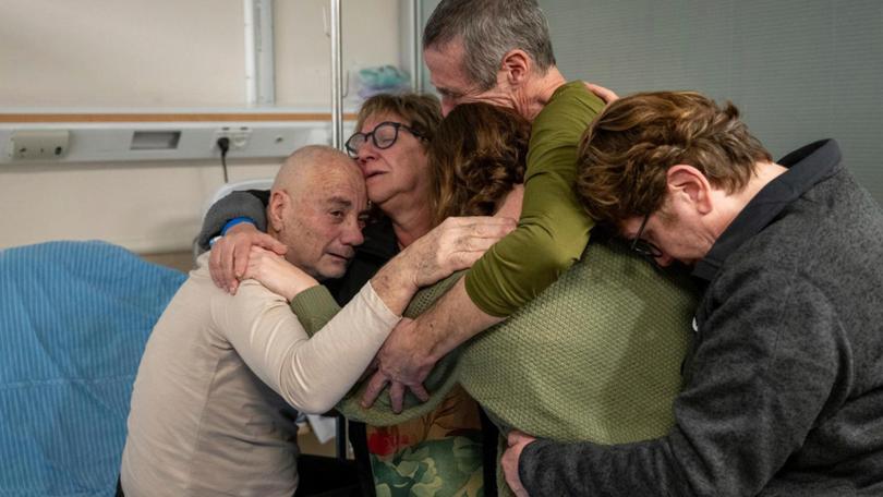 Hostage Luis Har, left, is hugged by relatives after being rescued from captivity in the Gaza Strip, at the Sheba Medical Center in Ramat Gan, Israel, Monday, Feb. 12, 2024. 