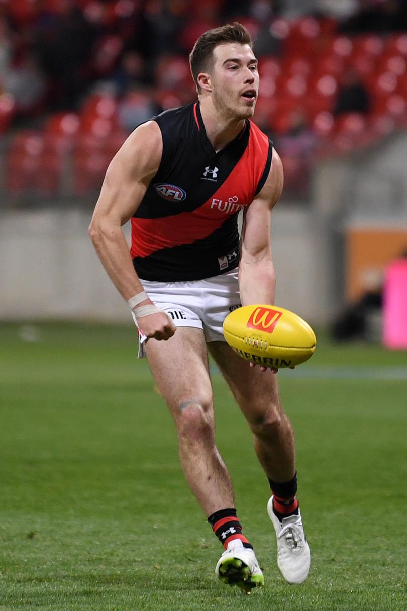 SYDNEY, AUSTRALIA - AUGUST 19: Zach Merrett of the Bombers handballs during the 2023 AFL Round 23 match between the GWS GIANTS and the Essendon Bombers at GIANTS Stadium on August 19, 2023 in Sydney, Australia. (Photo by Morgan Hancock/AFL Photos)