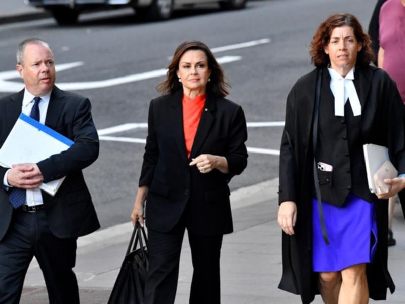 Lisa Wilkinson (centre) arrives at the Federal Court of Australia