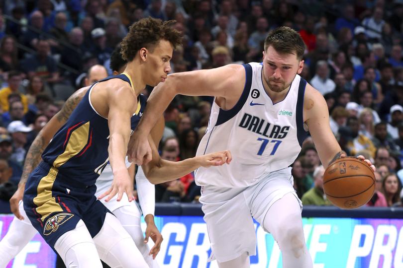 New Orleans Pelicans guard Dyson Daniels, left, guards Dallas Mavericks guard Luka Doncic (77) during the second half of an NBA basketball game Saturday, Jan. 7, 2023, in Dallas. (AP Photo/Richard W. Rodriguez)