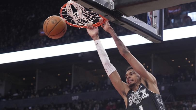 San Antonio Spurs center Victor Wembanyama (1) dunks against the Toronto Raptors during first-half NBA basketball game action in Toronto, Monday Feb. 12, 2024. (Chris Young/The Canadian Press via AP)