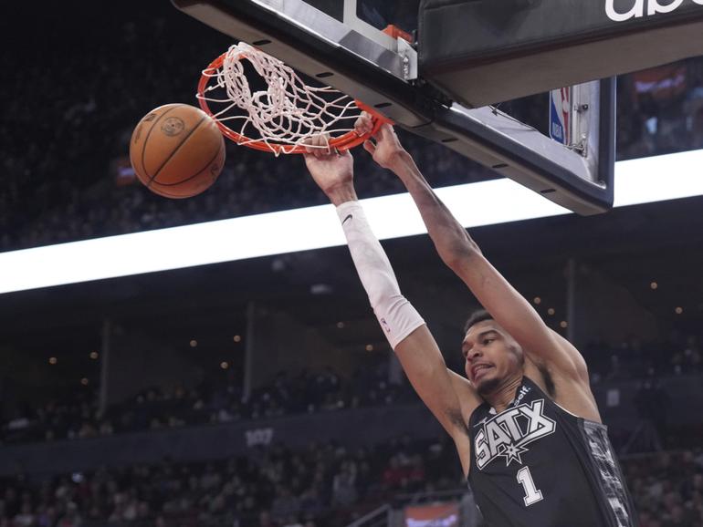 San Antonio Spurs center Victor Wembanyama (1) dunks against the Toronto Raptors during first-half NBA basketball game action in Toronto, Monday Feb. 12, 2024. (Chris Young/The Canadian Press via AP)