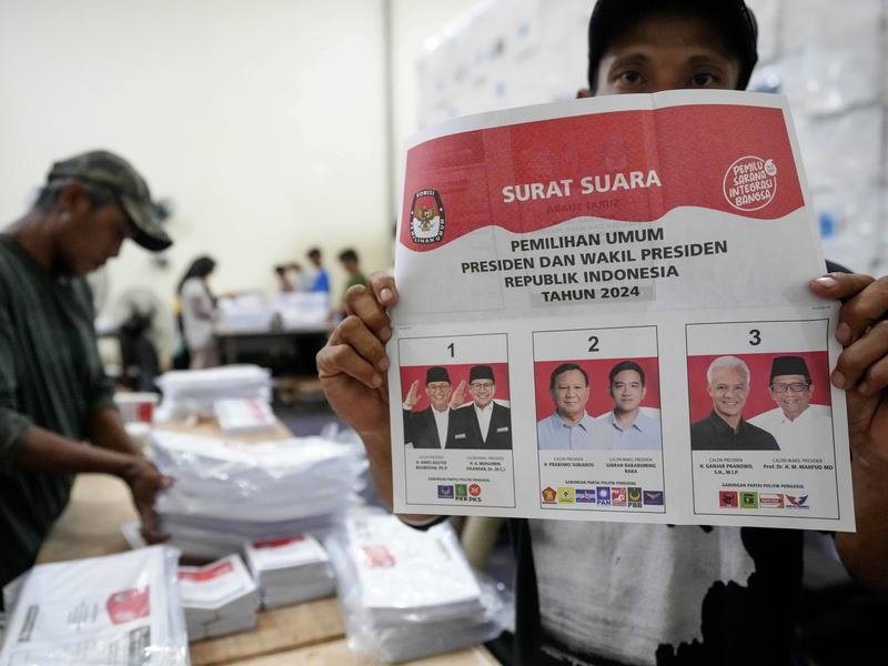 A worker shows ballot in South Tangerang, Indonesia