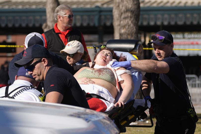 A person is taken to an ambulance. Credit: Charlie Riedel/AP
