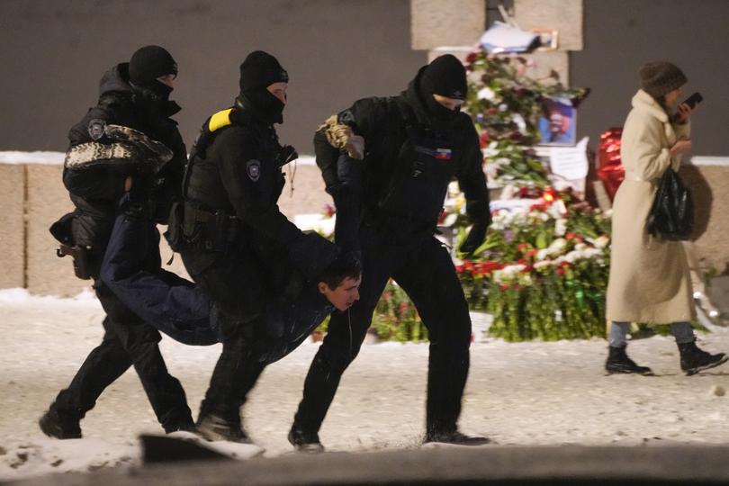 Police officers detain a man laying flowers to Alexei Navalny at the Memorial to Victims of Political Repression in St. Petersburg, Russia on Friday, Feb. 16, 2024. Russian authorities say that Alexei Navalny, the fiercest foe of Russian President Vladimir Putin who crusaded against official corruption and staged massive anti-Kremlin protests, died in prison. He was 47. (AP Photo)