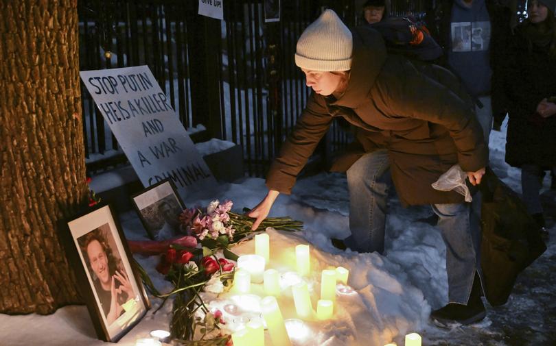 A person places flowers at a makeshift memorial for Alexei Navalny outside the Russian consulate in Montreal, Friday, Feb. 16, 2024. Alexei Navalny, who crusaded against official corruption and staged massive anti-Kremlin protests as President Vladimir Putin’s fiercest foe, has died in the Arctic penal colony where he was serving a 19-year sentence. (Graham Hughes/The Canadian Press via AP)