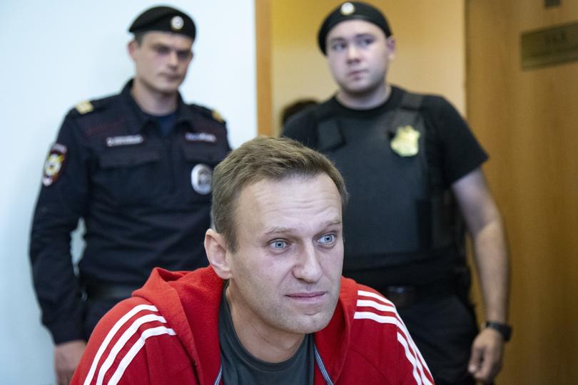 FILE- In this file photo taken on Thursday, Aug. 22, 2019, Russian opposition leader Alexei Navalny speaks to the media prior to a court session in Moscow, Russia. Russia came under renewed pressure to explain the nerve agent attack on opposition figure Alexei Navalny as the annual meeting of the global chemical weapons watchdog got underway in The Hague, Netherlands, Monday Nov. 30, 2020, amid measures aimed at reining in the spread of the coronavirus. (AP Photo/Alexander Zemlianichenko, File)