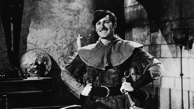 Actor Errol Flynn (1909 - 1959) poses in costume as Sir Robin of Locksley, from the film, 'The Adventures of Robin Hood,' directed by Michael Curtiz and William Keighley, 1938. (Photo by Warner Bros./Courtesy of Getty Images) 