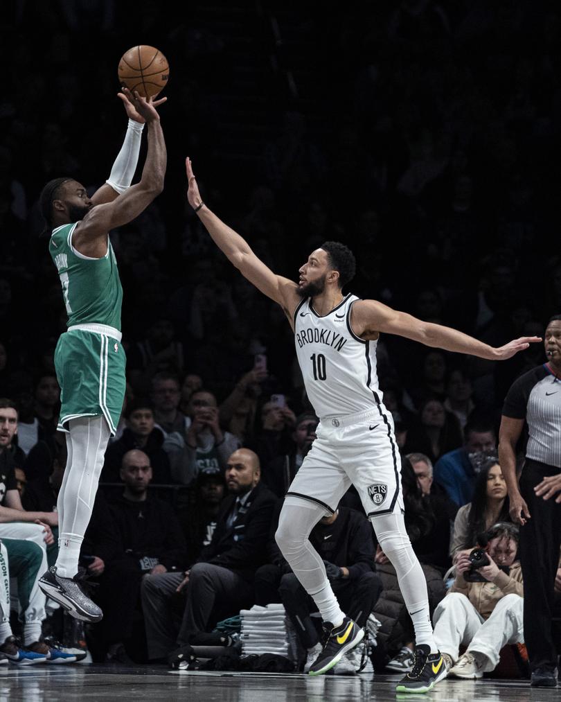 Brooklyn Nets guard Ben Simmons (10) defends as Boston Celtics guard Jaylen Brown (7) shoots a 3-pointer during the first half of an NBA basketball game in New York, Tuesday, Feb. 13, 2024. (AP Photo/Peter K. Afriyie)