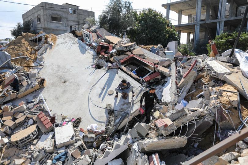 RAFAH, GAZA - FEBRUARY 20: People inspect the damage to their homes following Israeli air strikes on February 20, 2024 in Rafah, Gaza. Strikes have intensified as Israel reiterated its intent to press on with a ground offensive in Gaza's southern city of Rafah where some 1.4 million internally displaced Palestinians are sheltering, whilst a growing number of countries express alarm over the operation. (Photo by Ahmad Hasaballah/Getty Images)