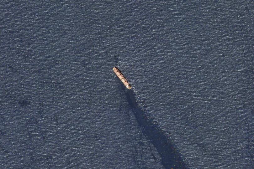 In this satellite image provided by Planet Labs, the Belize-flagged bulk carrier Rubymar is seen in the southern Red Sea near the Bay el-Mandeb Strait leaking oil after an attack by Yemen's Houthi rebels Tuesday, Feb. 20, 2024. Despite a month of U.S.-led airstrikes, Yemen's Iran-backed Houthi rebels remain capable of launching significant attacks. This week, they seriously damaged a ship in a crucial strait and apparently downed an American drone worth tens of millions of dollars. (Planet Labs PBC via AP)