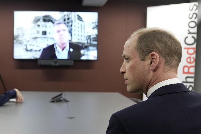 Britain's Prince William, The Prince of Wales, listens to Pascal Hundt, Senior Crisis Manager, International Committee of the Red Cross, dialling in from Gaza, during a visit of the British Red Cross at its headquarters in London, Tuesday, Feb. 20, 2024. The Prince of Wales undertakes engagements which recognise the human suffering caused by the ongoing war in the Middle East and the subsequent conflict in Gaza, as well as the rise of antisemitism around the world. The Red Cross are providing humanitarian aid in the region via the Red Cross Red Crescent Movement, including Magen David Adom in Israel and the Palestine Red Crescent Society. (AP Photo/Kin Cheung, Pool)