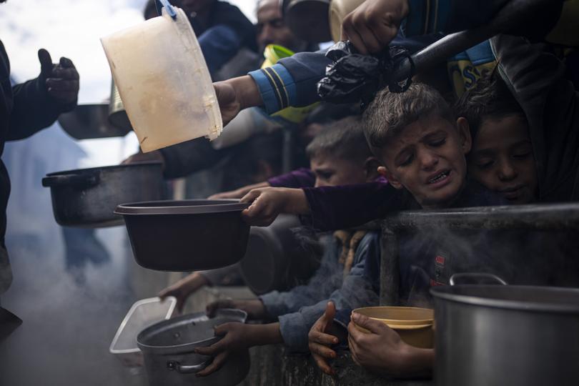 Palestinians line up for a free meal in Rafah.