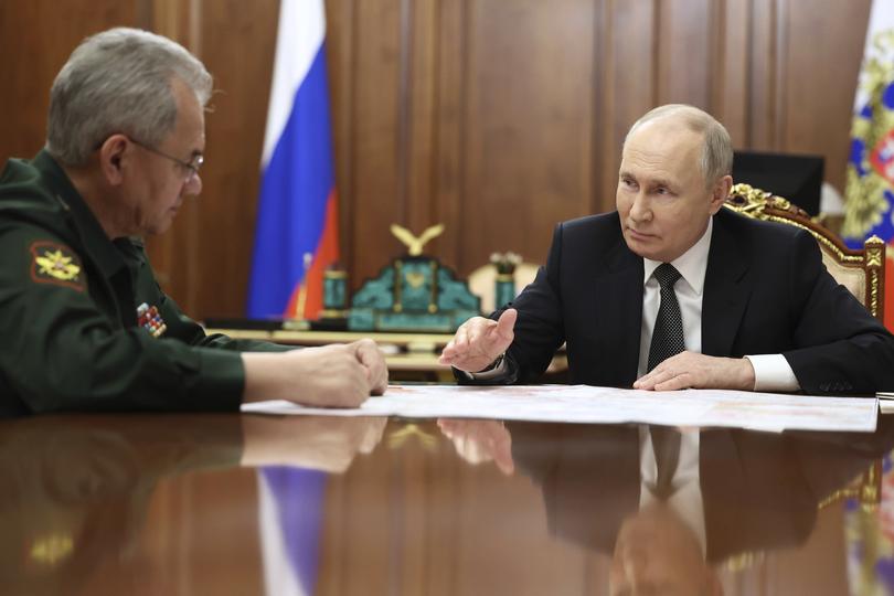 Russian President Vladimir Putin, right, speaks to Russian Defense Minister Sergei Shoigu durning their meeting at the Kremlin in Moscow, Russia, Tuesday, Feb. 20, 2024. (Alexander Kazakov, Sputnik, Kremlin Pool Photo via AP)