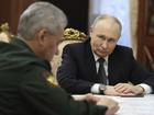 Russian President Vladimir Putin, right, listens to Russian Defense Minister Sergei Shoigu.