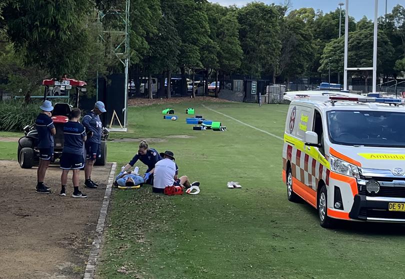Wallabies centre Lalakai Foketi being treated for a neck injury at NSW Waratahs training in Sydney on Thursday.