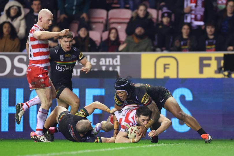 WIGAN, ENGLAND - FEBRUARY 24: Jake Wardle of Wigan Warriors goes down before going over to score his team's third try during the Betfred World Club Challenge match between Wigan Warriors and Penrith Panthers at DW Stadium on February 24, 2024 in Wigan, England. (Photo by Lewis Storey/Getty Images)