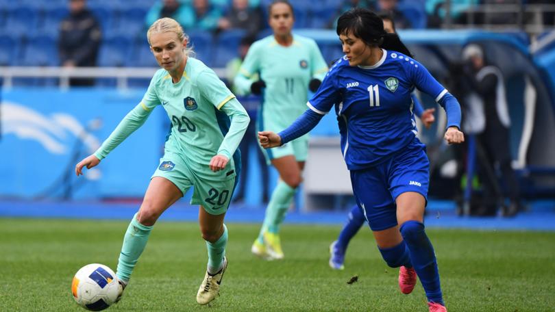 Kaitlyn Torpey battles for possession with Maftuna Shoyimova of Uzbekistan.