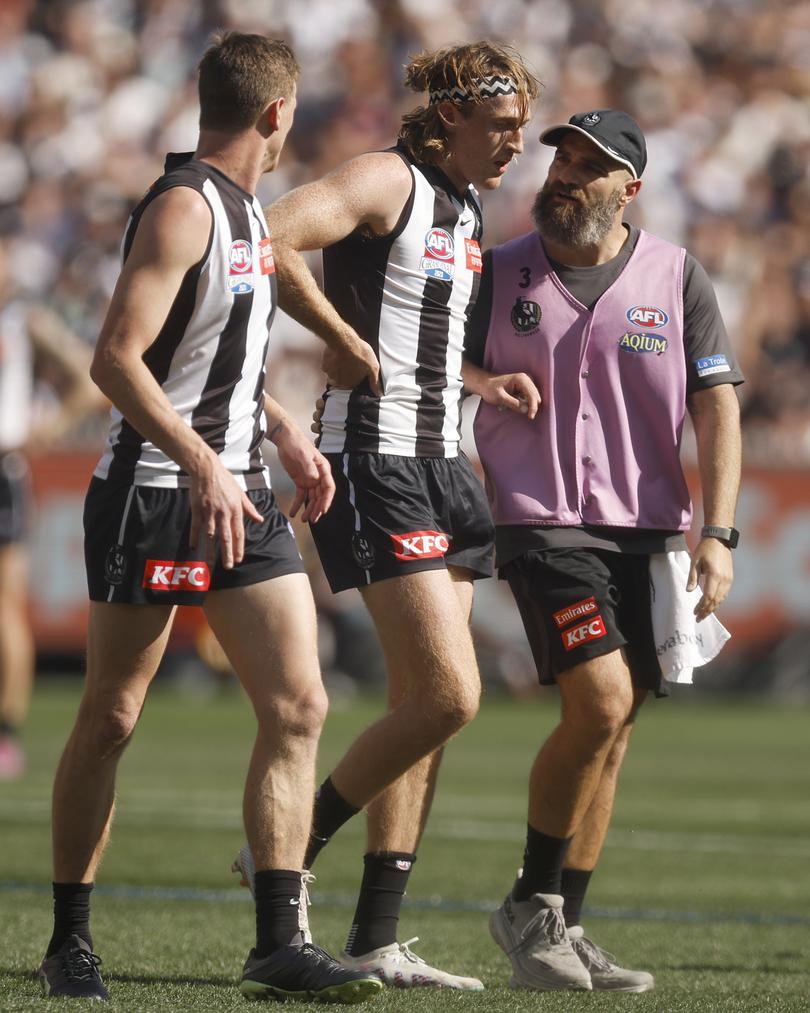 MELBOURNE, AUSTRALIA - SEPTEMBER 30: Nathan Murphy of the Magpies leaves the field with trainers during the 2023 AFL Grand Final match between Collingwood Magpies and Brisbane Lions at Melbourne Cricket Ground, on September 30, 2023, in Melbourne, Australia. (Photo by Daniel Pockett/AFL Photos/via Getty Images)