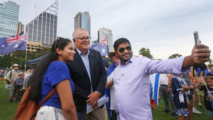  Former Australian Prime Minister Scott Morrison (L) takes a selfie with a supporters during a rally against antisemitism.