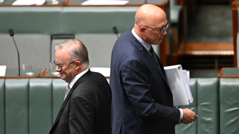 Anthony Albanese walks past Australian Opposition Leader Peter Dutton.