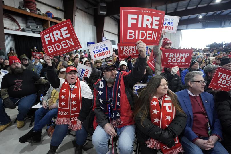 Supporters hold signs before Republican presidential candidate former President Donald Trump attends a campaign rally in Waterford Township, Mich., Saturday, Feb. 17, 2024. (AP Photo/Paul Sancya)