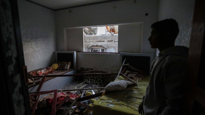 People inspect damage to their homes following Israeli air strikes on February 24, 2024 in Rafah, Gaza. 