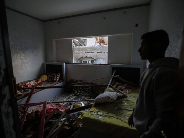 People inspect damage to their homes following Israeli air strikes on February 24, 2024 in Rafah, Gaza. 