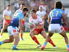  Tom Gilbert of the Dolphins takes on the defence during the NRL Pre-season challenge match between the Dolphins and Gold Coast Titans.