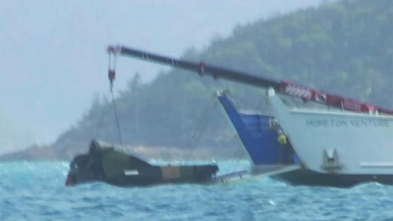 Wreckage from the MRH-90 Taipan is hauled from the water after the deadly crash in Queensland. (HANDOUT/NINE NEWS)
