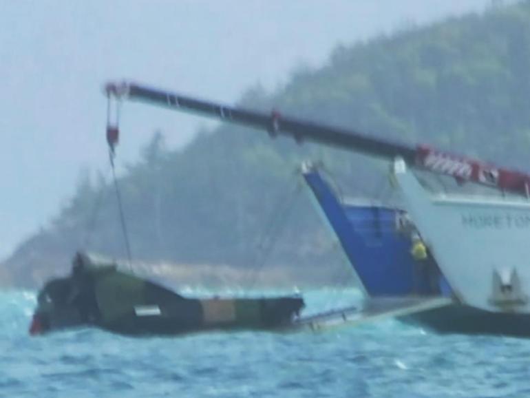 Wreckage from the MRH-90 Taipan is hauled from the water after the deadly crash in Queensland. (HANDOUT/NINE NEWS)